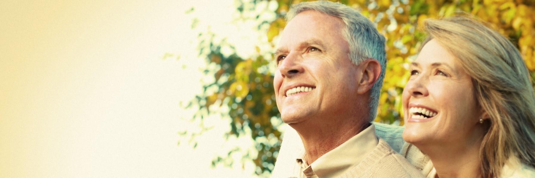 Older couple smiling looking upward l Porcelain Veneers Monroe MI